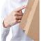 A person in a white shirt is using a finger to open a cardboard box at a perforated section.