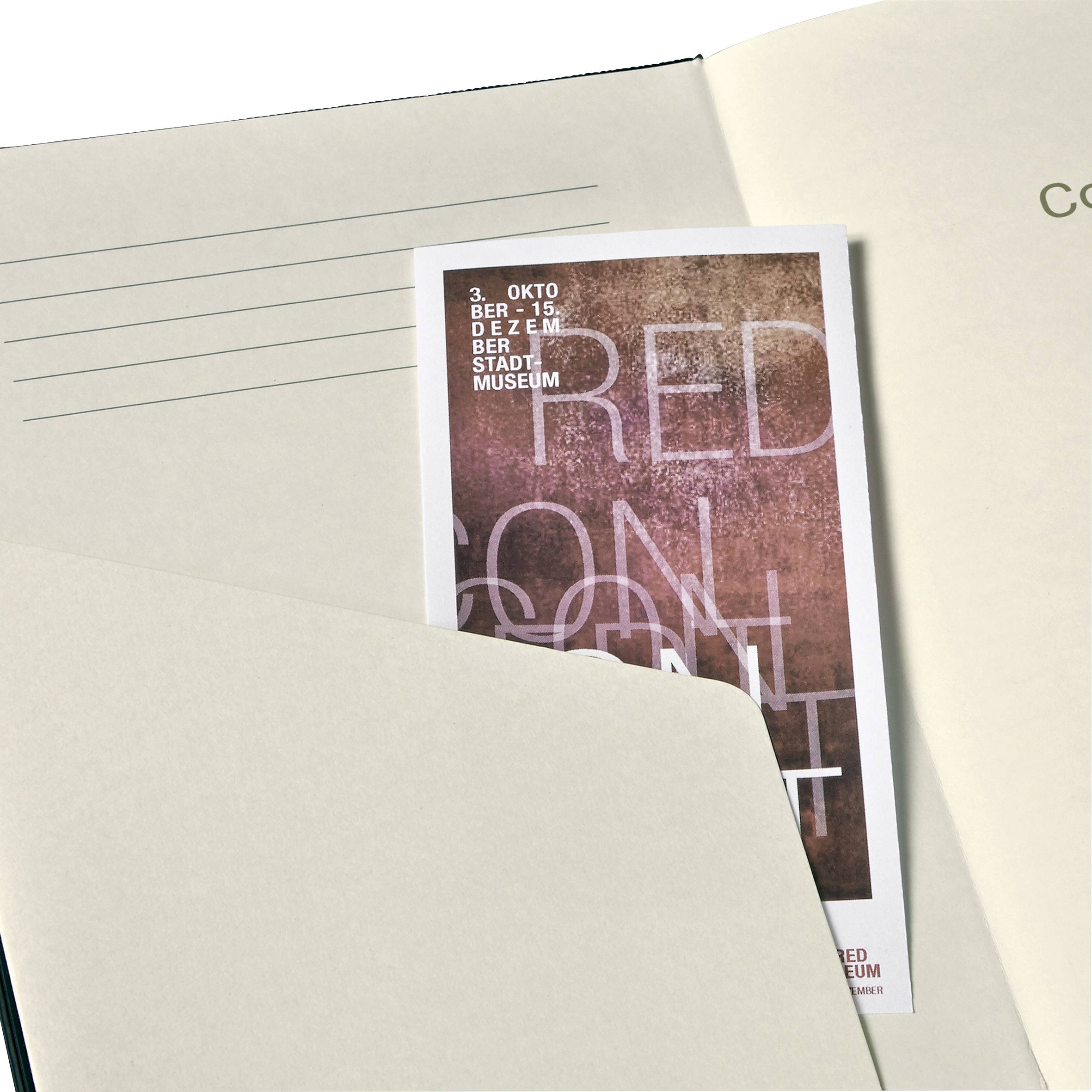 A ticket with a red, textured background is tucked into a book. It reads: '30 OCTOBER - 15 DEC, CITY MUSEUM'.