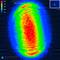False-colour thermal image shows an oval shape in intense red tones, surrounded by cooler greens and blues, scale 250 microns.