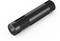 A long, cylindrical black torch rests on a white surface. It has a minimalist design.
