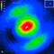 Thermal image shows a central red zone, surrounded by green and blue areas, representing thermal radiation in microns.