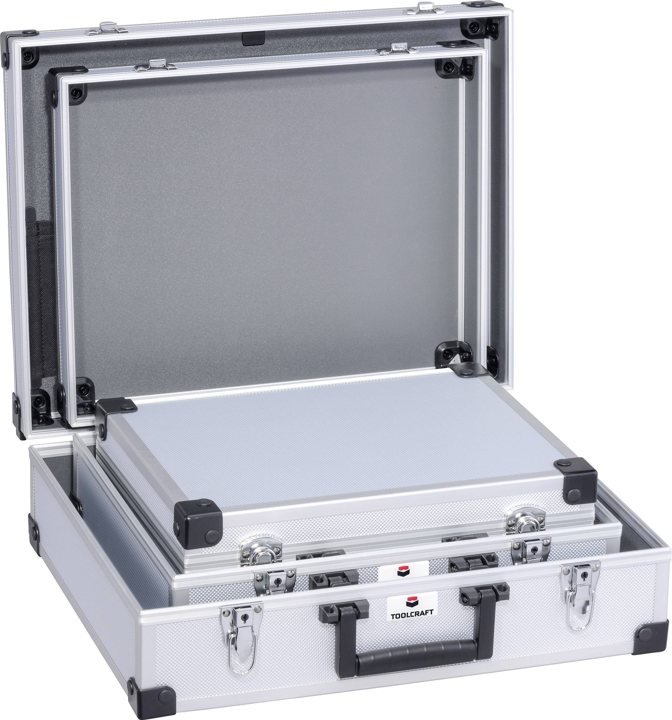 An opened silver toolbox with a black handle, reinforced corners, and prominent latches. Inside, another case.