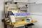 Workbench with tools on the wall, laptop, document holder and sorted storage boxes on the table.
