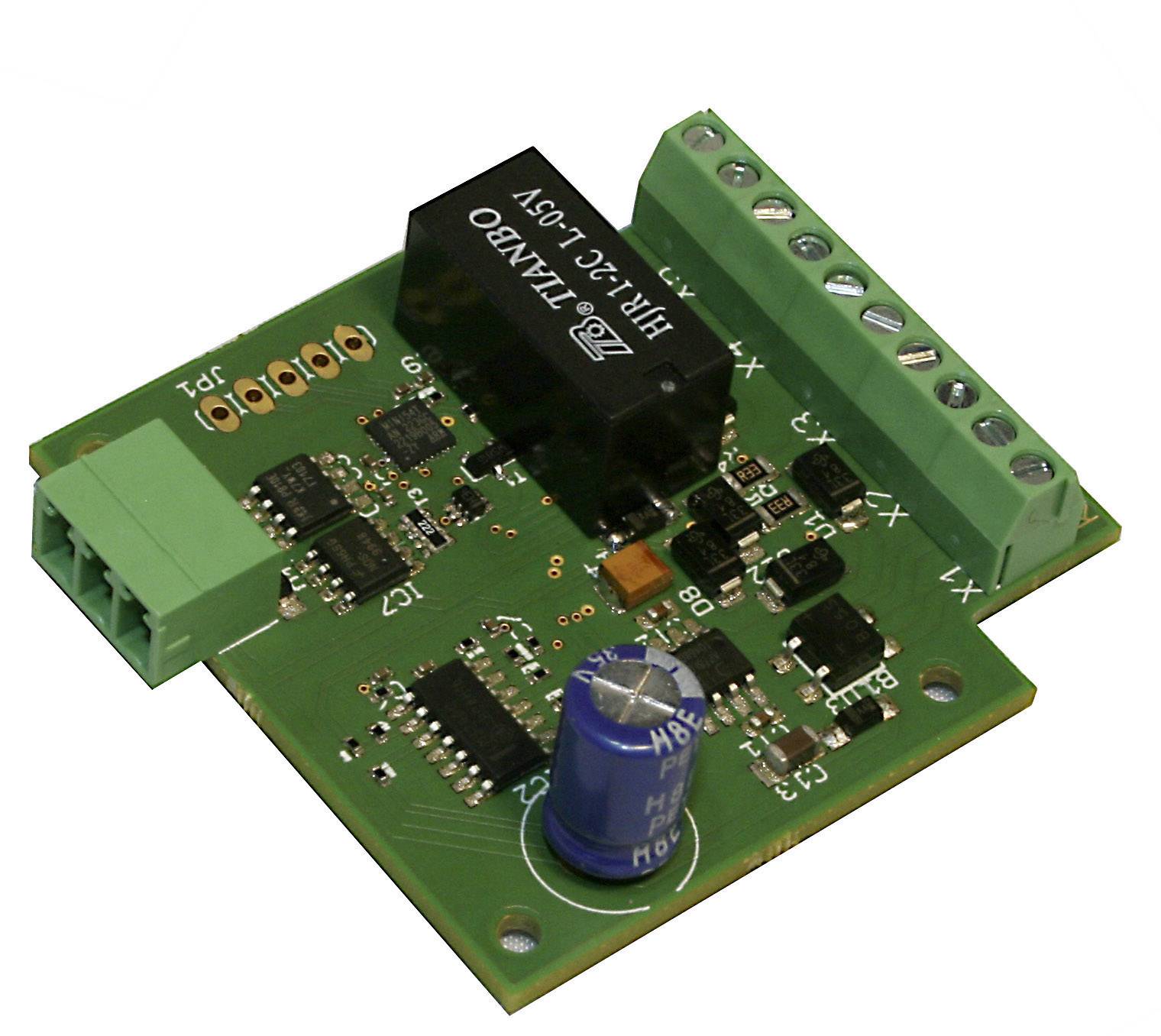 'Photo of a green circuit board with multiple black and silver components and a blue capacitor.'