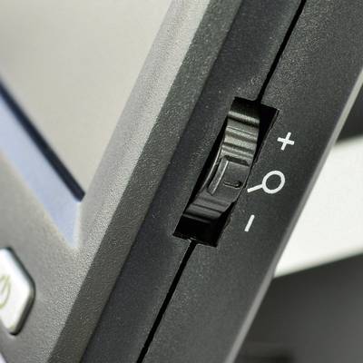 Side view of a screen focusing on the brightness dial, showing plus and minus symbols for adjusting brightness.