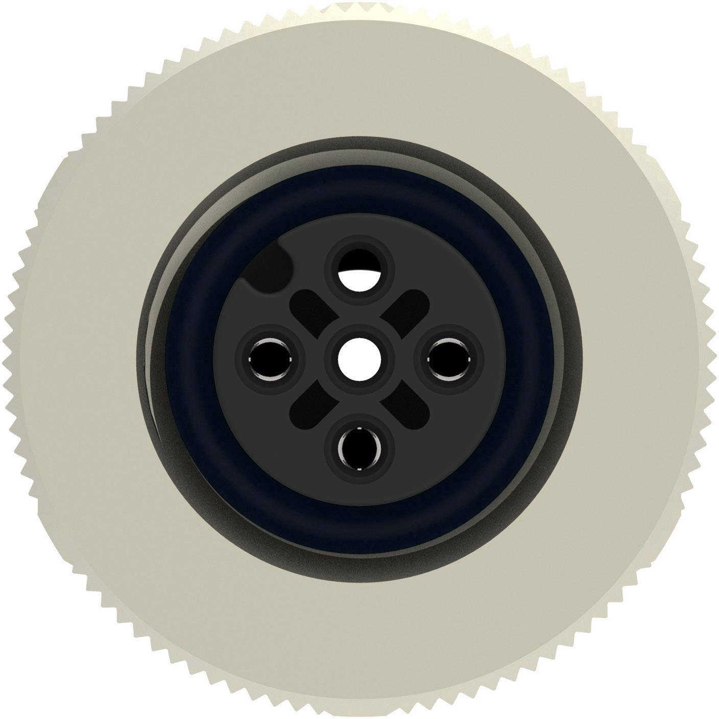 A circular, beige razor head with a black centre and multiple cutting apertures, viewed from an overhead perspective.