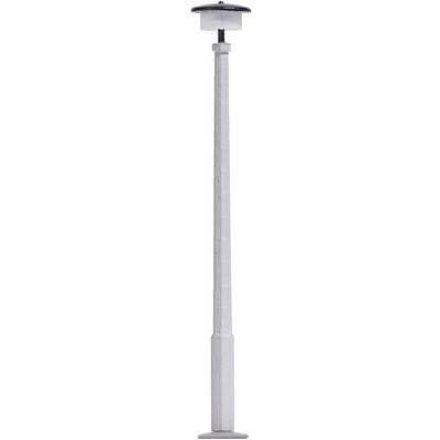 A view of a telescopic-style metal rod with adjustable height, with a round, flat base at one end and a cap at the other.