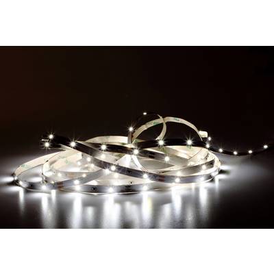 A luminous LED light strip is draped in loops on a dark surface, emitting white light.