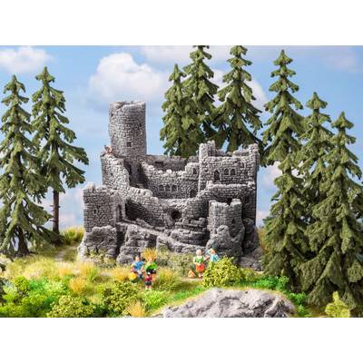 A miniature landscape depicts a medieval castle ruin surrounded by tall pine trees. In the foreground, small figures can be seen.