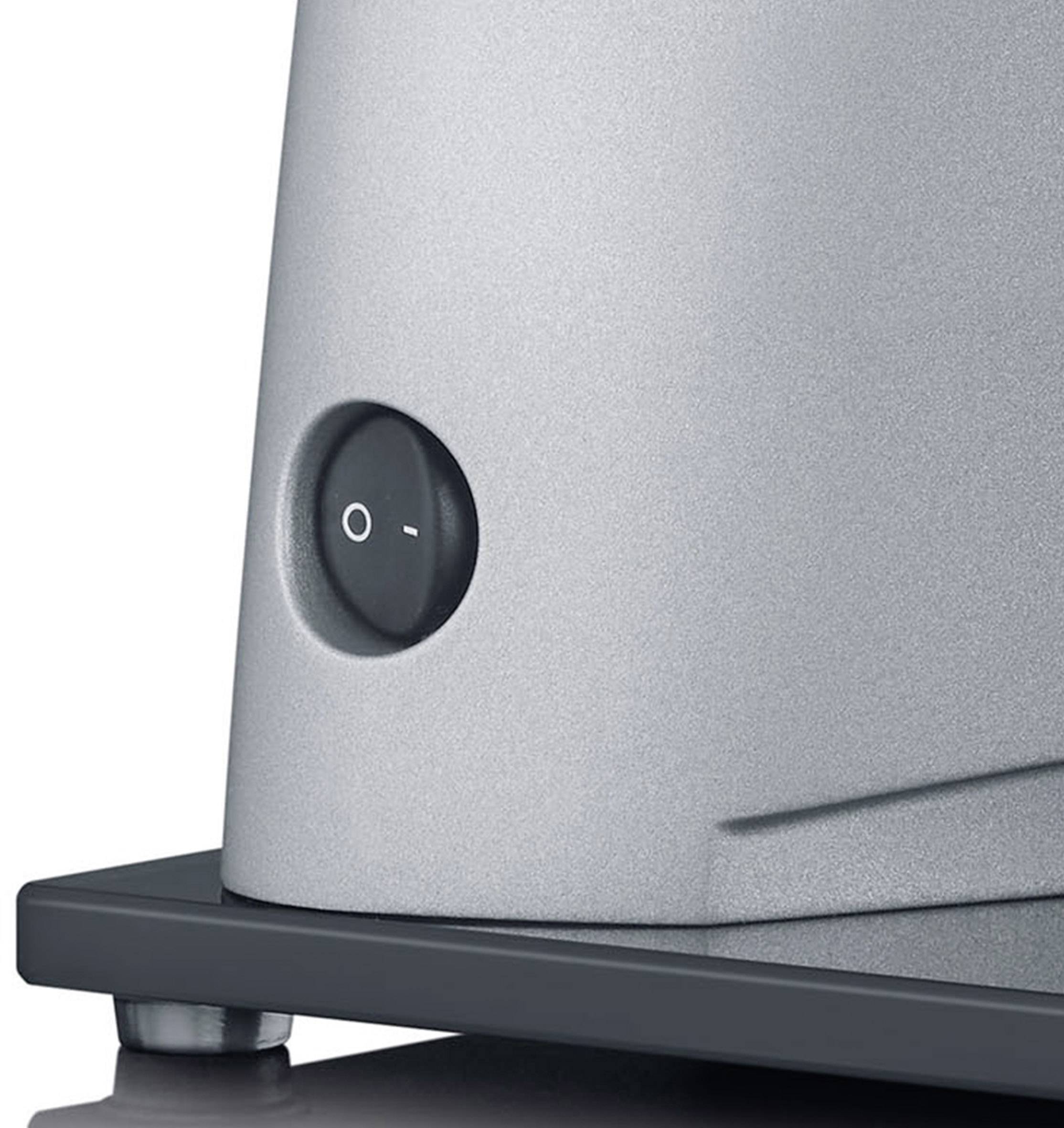 Close-up of a silver switch with an 'O-I' symbol on a metal surface.