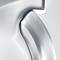Close-up of a silver, gleaming metal surface detail with smooth curves and edges, potentially part of a household appliance.