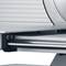 Close-up of a silver industrial device with gleaming metal rollers and smooth surfaces, potentially part of a machinery.