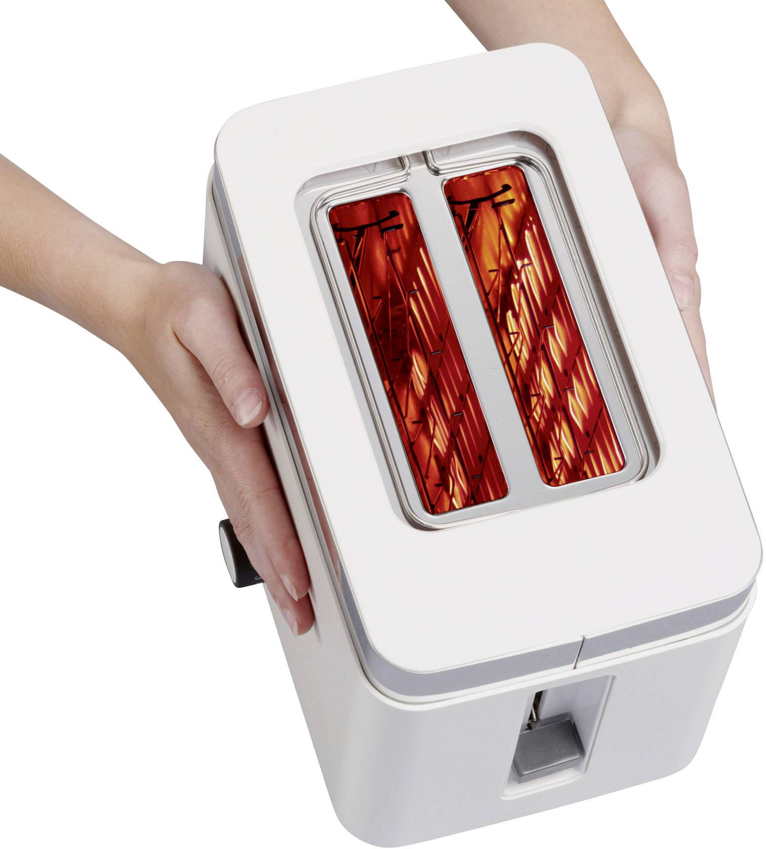 A person is holding a white toaster. The heating elements inside are glowing red, indicating that the toaster is in operation.