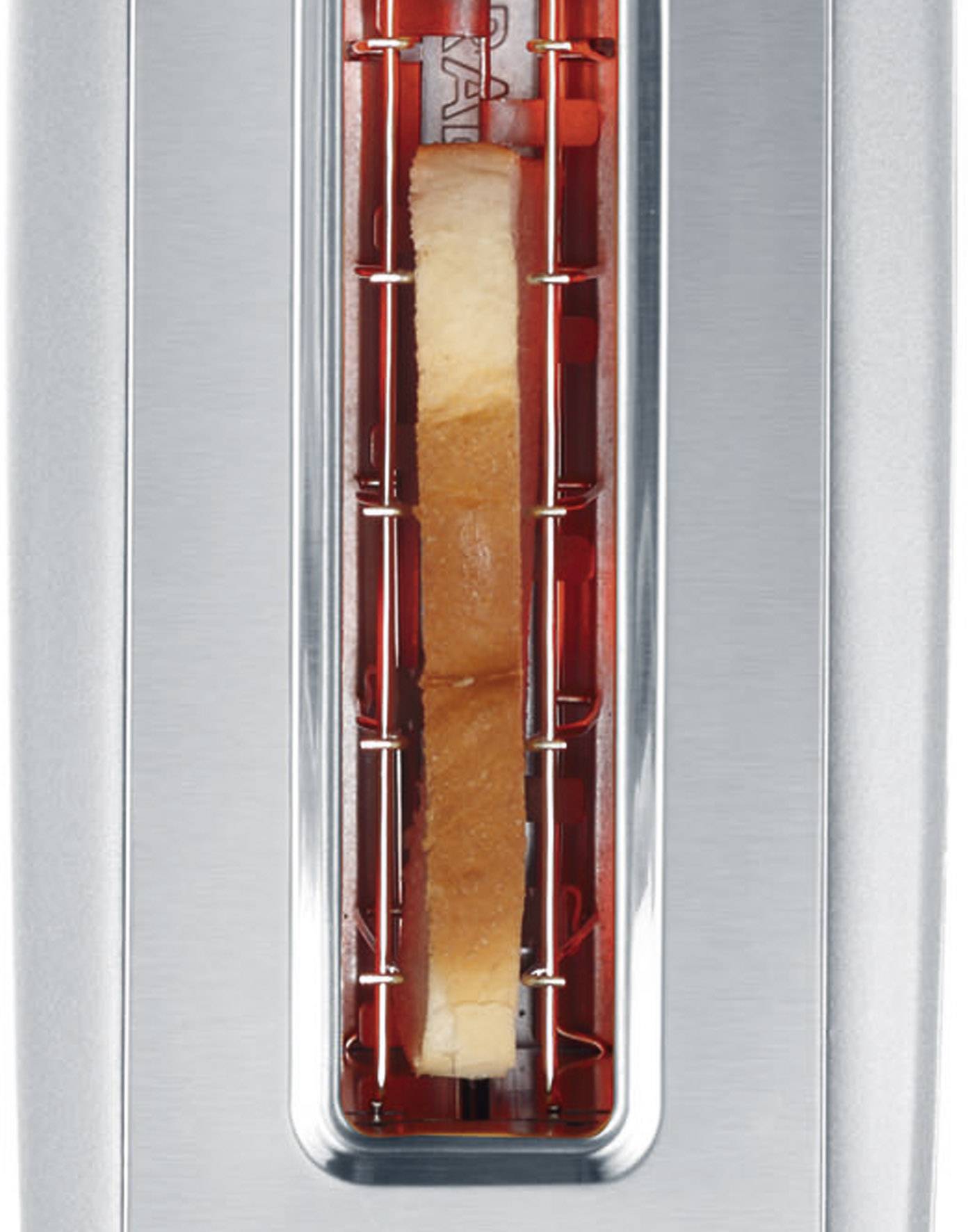 A close-up of a silver toaster with a slice of bread being toasted. The toaster glows red from the heat.