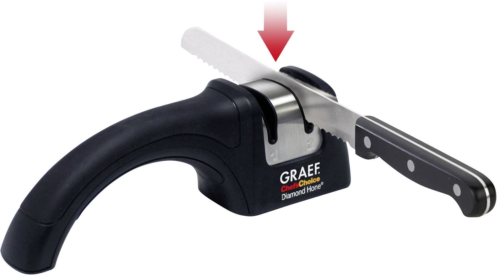 Black and silver knife sharpener by Graef with a serrated knife inserted and a red arrow indicating the sharpening direction.