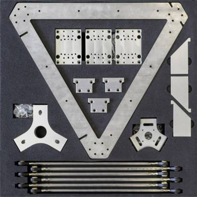 Metal parts in foam lining: three triangular steel plates, various smaller plates, screws and rods. Assembly kit.