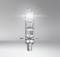A luminous halogen lamp hovering in a grey room draws focus to its complex inner structure and emitted light.