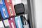 A black square device with the inscription 'P-Touch Cube' sits on a shelf. Coloured folders are positioned beside it.