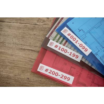 Three folders with plans are lying on a wooden table. They are numbered '#001-099', '#100-199', and '#200-299'.