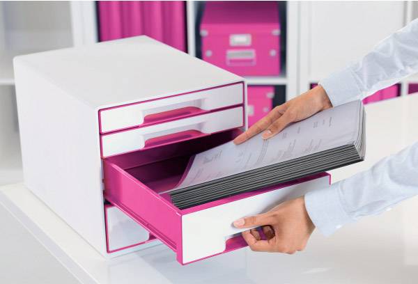 A person is pulling a stack of documents from a white and pink drawer box. In the background, shelves with pink boxes can be seen.