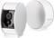 Two silver surveillance cameras by Somfy with rounded edges stand side by side; one shows the lens, the other the logo.