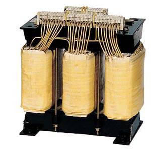 Three-phase transformer with visible windings and connections on a black base, used for voltage conversion.