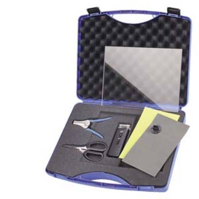 A tool case with foam lining contains a pair of scissors, a pair of pliers, a measuring device and two sheets of paper.