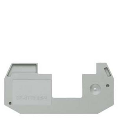 A grey, rectangular plastic component with various protrusions and a small round elevation on the right side.