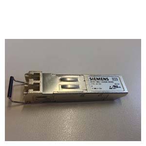 A silver Siemens X3 module for network applications lies on a grey surface.