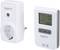 A white, programmable socket and a thermostat with display screen and control buttons for temperature and humidity regulation.
