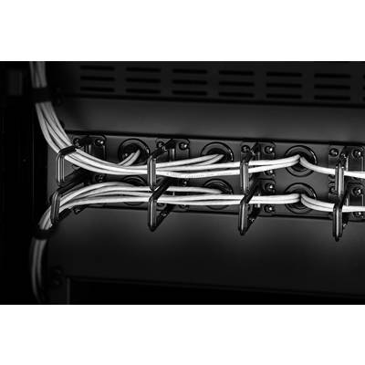 White cables are neatly secured in black cable clips on a back wall.