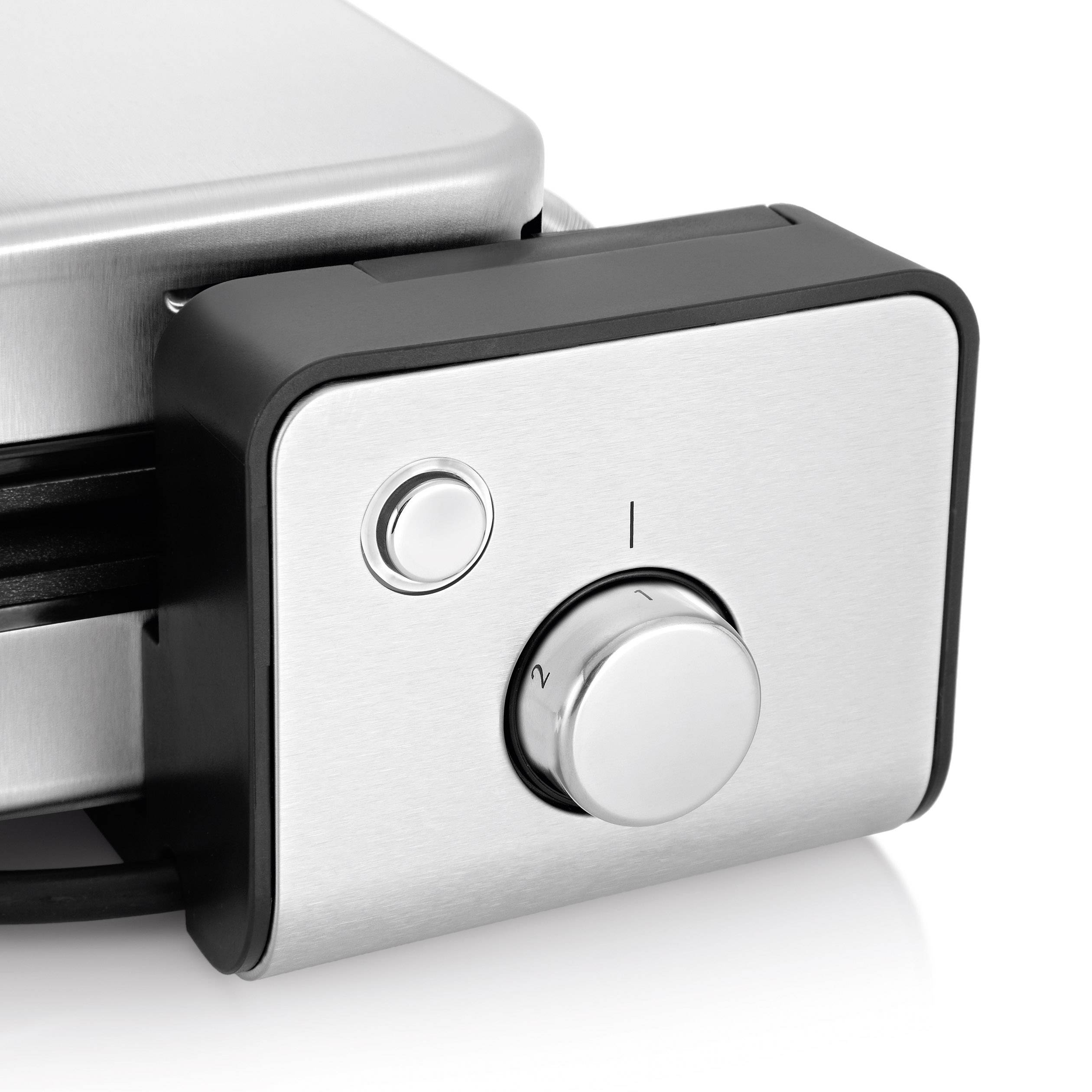 A silver, angular waffle maker with a temperature control dial, set to level 2.