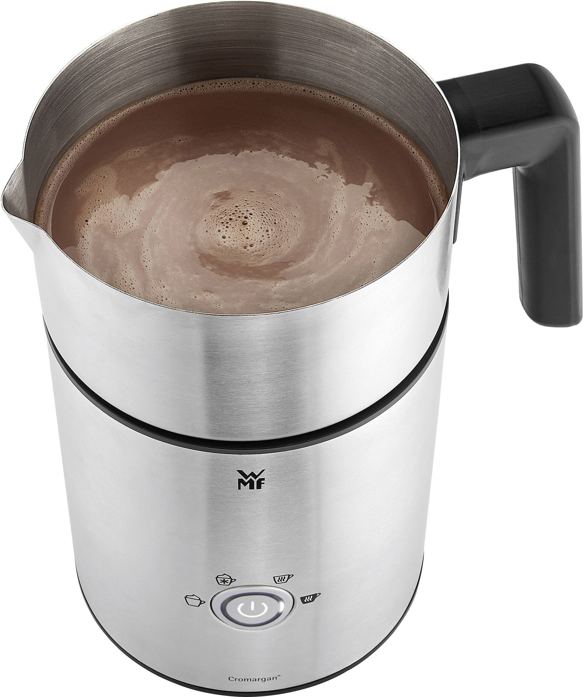 A silver milk frother, filled with frothy cocoa. The container has a black handle and control buttons on the front.