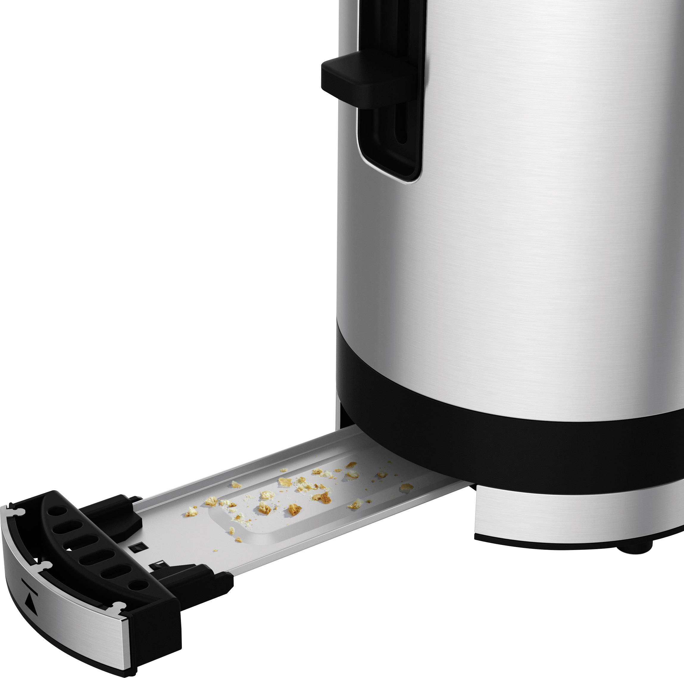 A toaster with a pulled-out crumb tray containing breadcrumbs.
