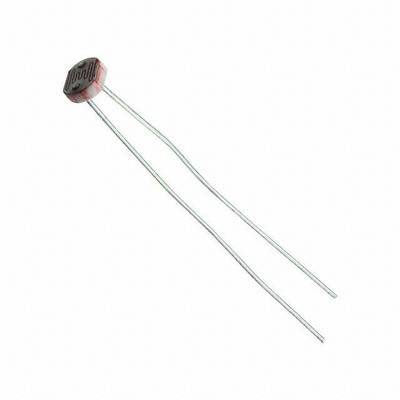 A photoresistor with two long metallic wire connections. It is used for light measurement.