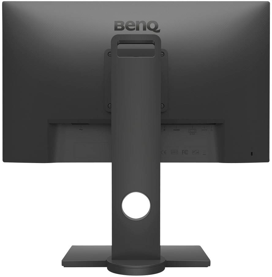 A computer monitor viewed from behind, with a distinctive stand and a prominent round hole in the lower area of the stand.