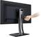 A screen is shown from behind, with a hand gripping the stand to demonstrate its stability or manoeuvrability.