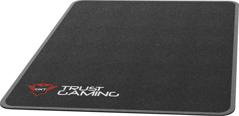 A black gaming mouse mat with a red logo and the inscription 'Trust Gaming', showing a smooth surface for precise mouse movements.