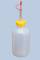 Plastic bottle with a yellow cap and a long, pointed spout against a blue background. Suitable for precise liquid dispensing.
