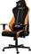 An ergonomic gaming chair in black and orange, with a high backrest, adjustable armrests and a lumbar support cushion.