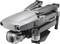 A grey drone with a camera, model 'Mavic 2', on a white surface.