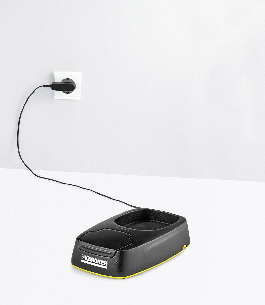 A charging base for a device, plugged into a socket, on a table.