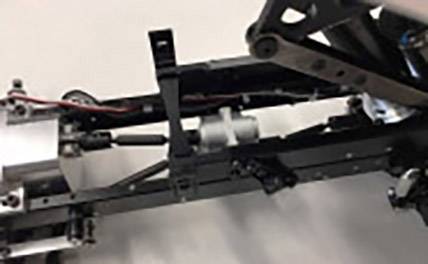 'Close-up of a mechanical device with levers and cables, possibly part of a machine or robot.'