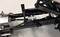 'Close-up of a mechanical device with levers and cables, possibly part of a machine or robot.'