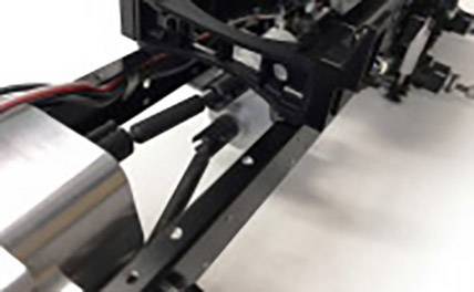 Close-up of a technical device with metal and plastic components. Cables are connected, potentially part of a machine or model.