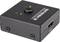 Black HDMI switcher with two inputs, a central button and LED indicators for input 1 and 2.