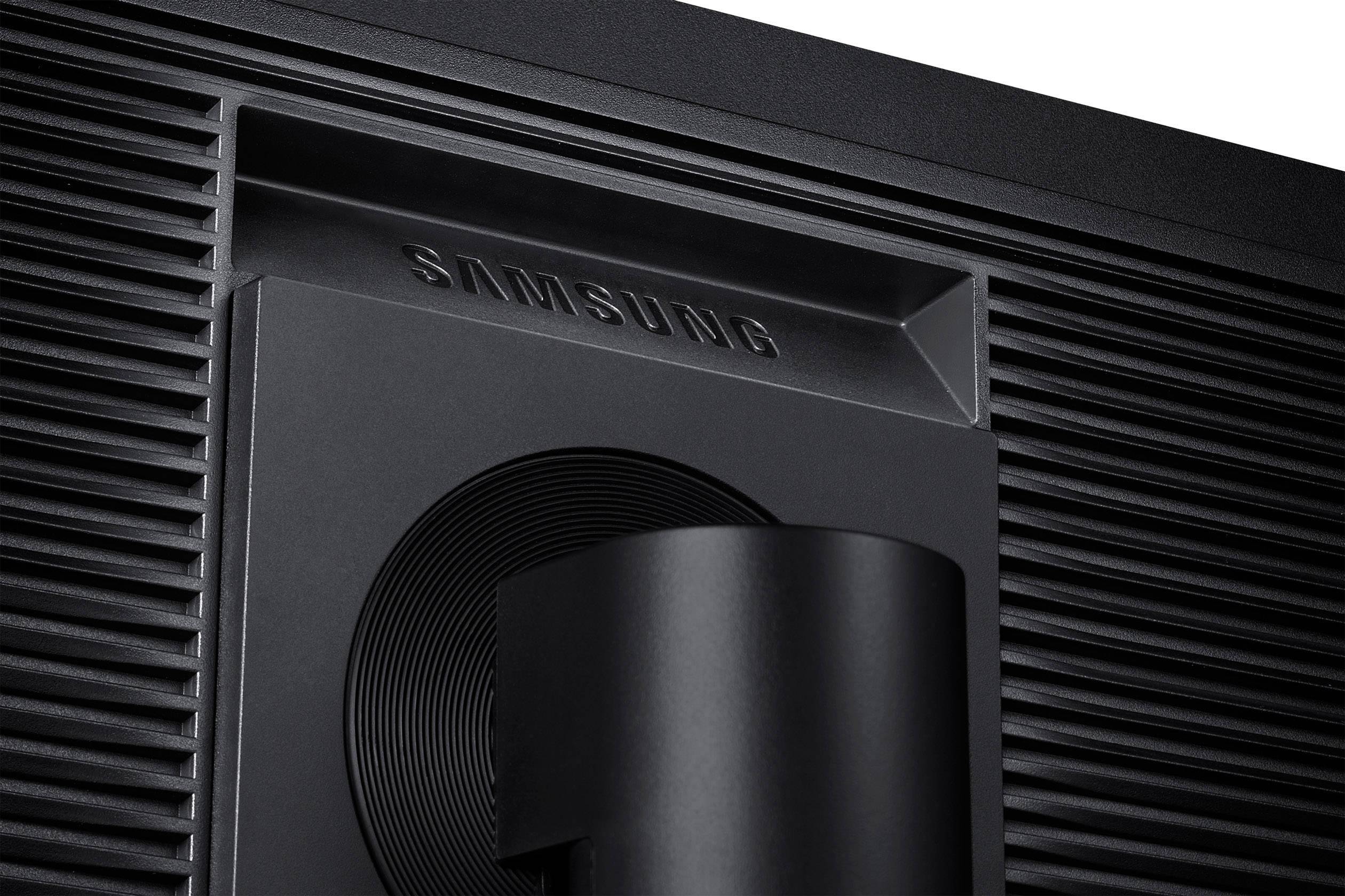 Back of a Samsung monitor with raised logo and textured design, cable routing visible through the stand.