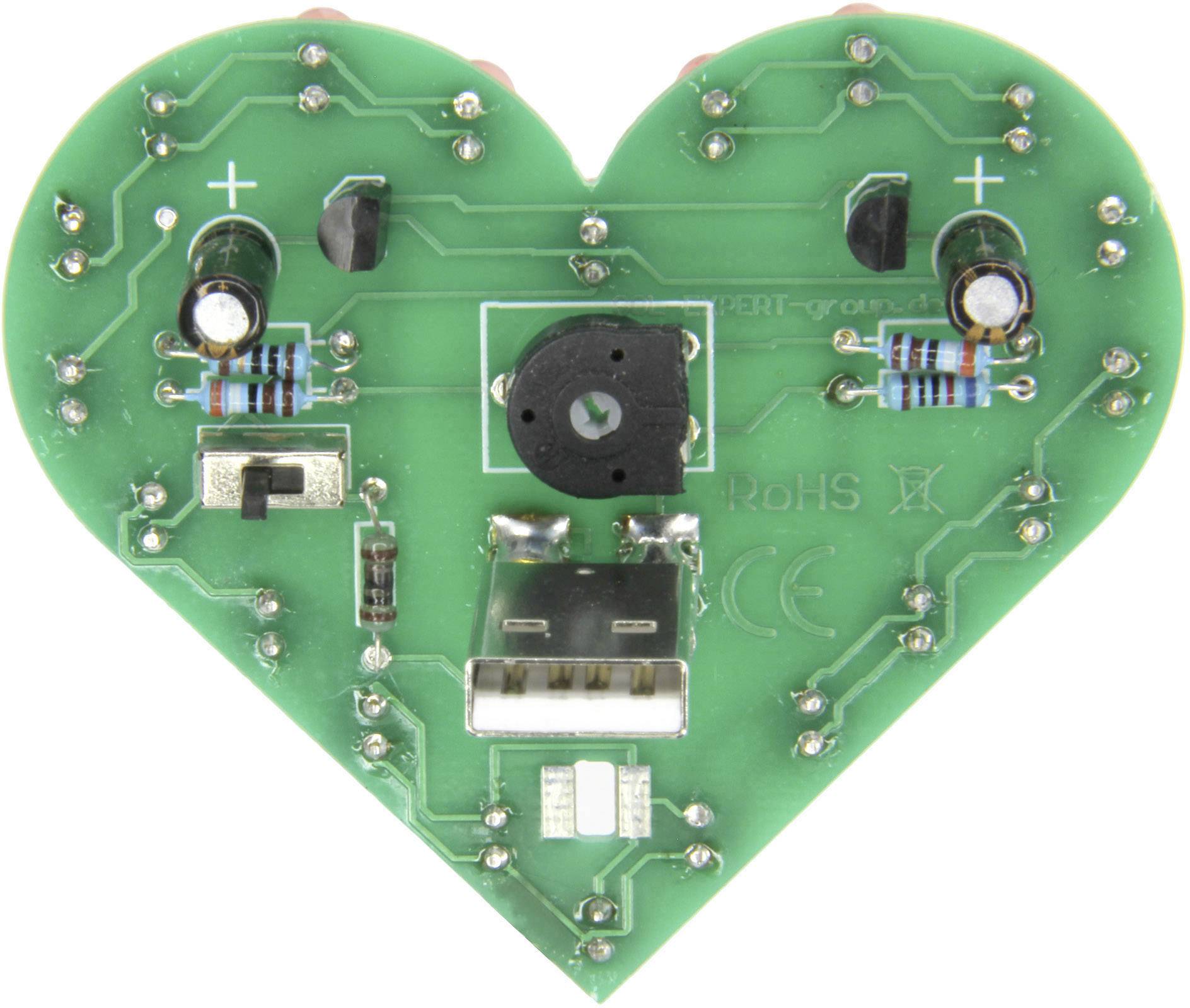 Green, heart-shaped printed circuit board with electronic components, such as resistors and USB port, symbolises technology and innovation.