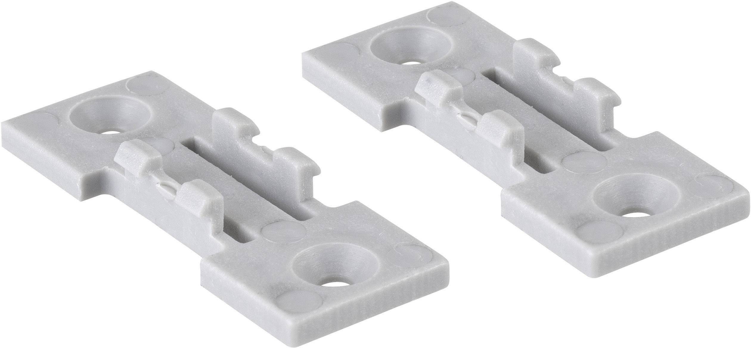 Two grey plastic mounting clips for furniture assembly, lying side by side, each with three round holes.