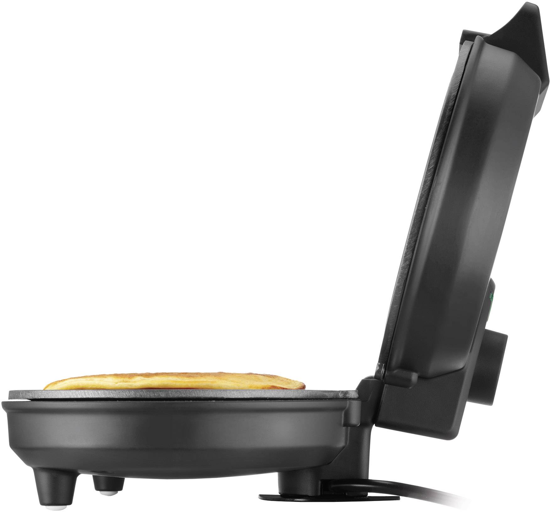 A waffle iron shows a golden brown waffle on the lower plate, with the upper part open.